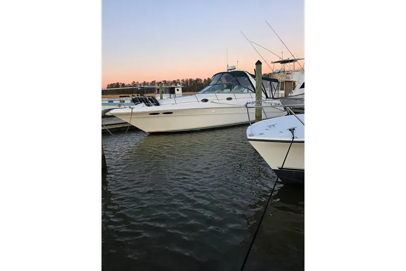 Slide: The Image of 2000 Sea Ray 340 Sundancer yacht docked at sunset, calm waters. - 63