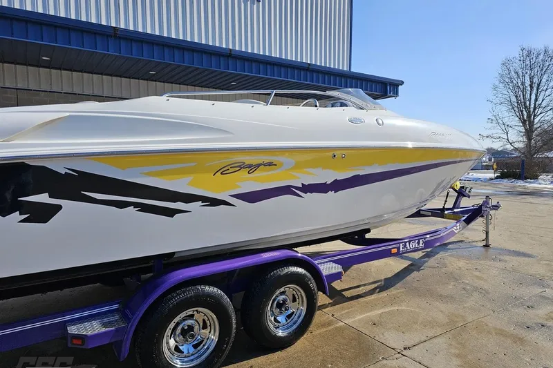 Slide: The Image of 2003 Baja 275 Boss speedboat on a purple trailer, featuring vibrant graphics. - 10