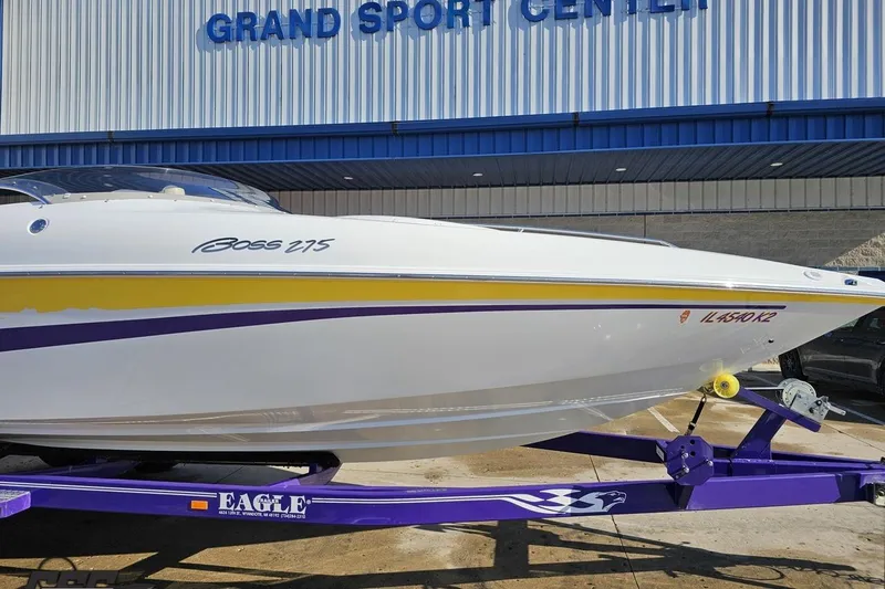 Slide: The Image of 2003 Baja 275 Boss boat on a purple trailer at Grand Sport Center. - 13