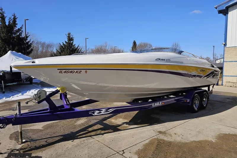 Slide: The Image of 2003 Baja 275 Boss speedboat on a purple trailer, parked outdoors on a sunny day. - 18