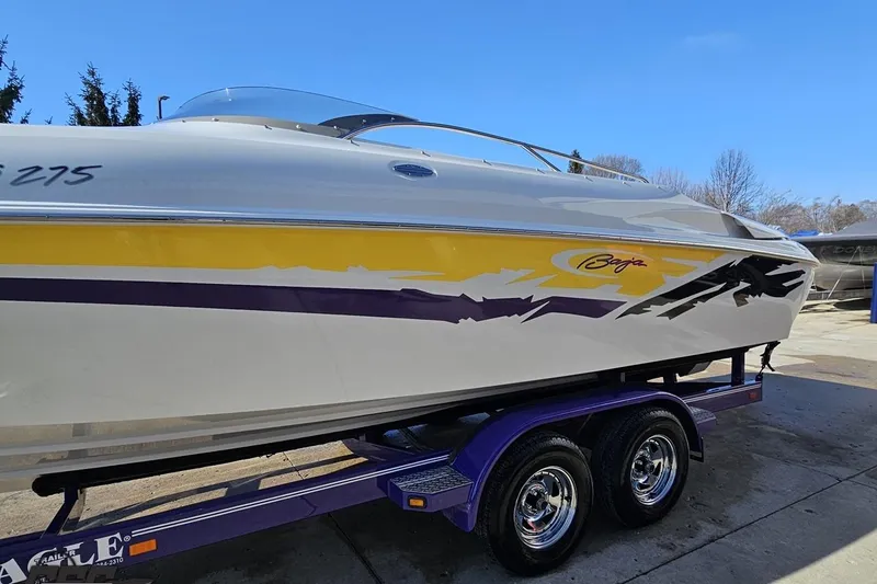 Slide: The Image of 2003 Baja 275 Boss speedboat on trailer, featuring vibrant yellow and purple graphics. - 21