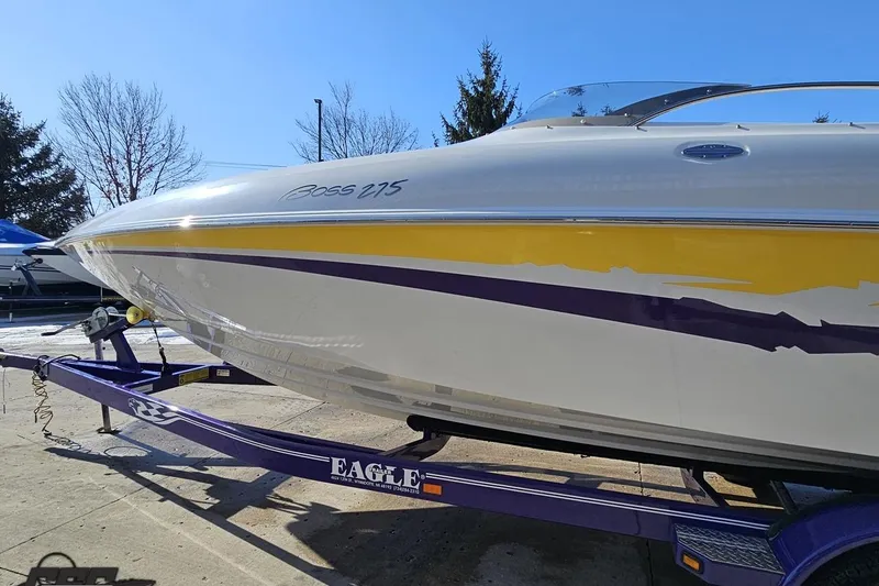 Slide: The Image of 2003 Baja 275 Boss boat on a purple trailer, featuring yellow and purple accents. - 24