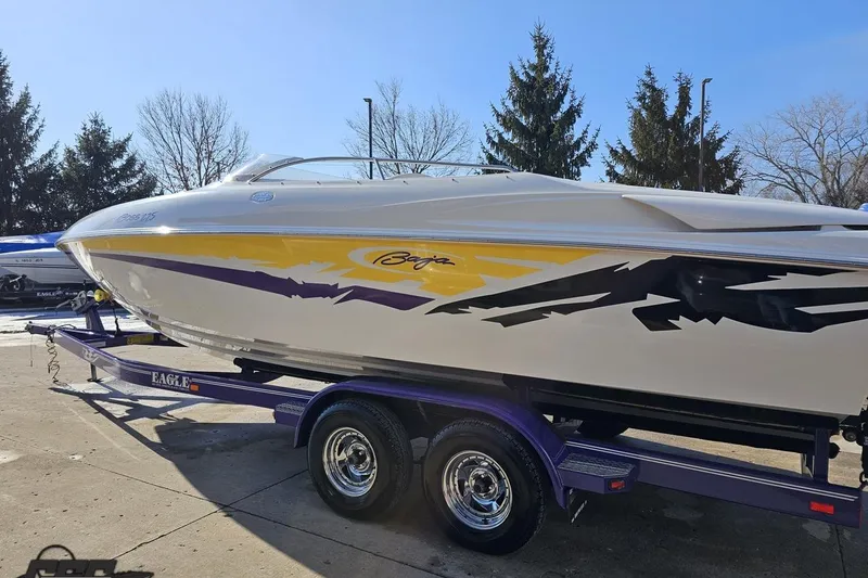 Slide: The Image of 2003 Baja 275 Boss speedboat on a trailer, featuring vibrant graphics and sleek design. - 25