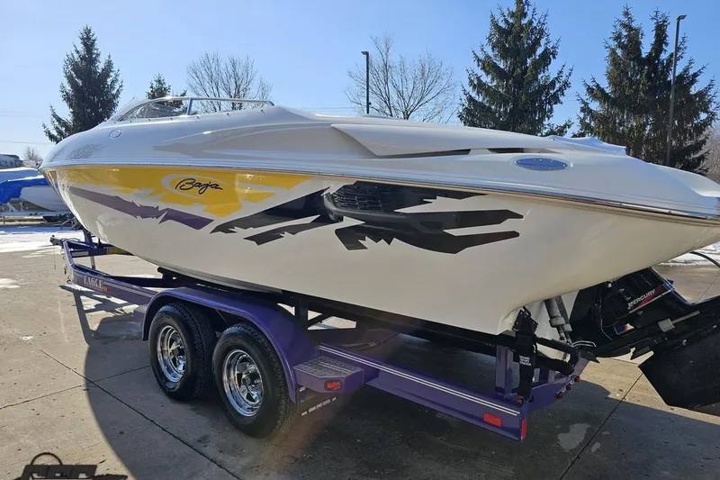 Slide: The Image of 2003 Baja 275 Boss speedboat on trailer, featuring vibrant yellow and black graphics. - 26