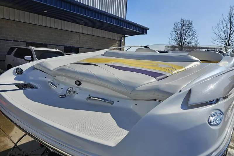 Slide: The Image of 2003 Baja 275 Boss boat with sleek design and vibrant upholstery, parked outdoors. - 37