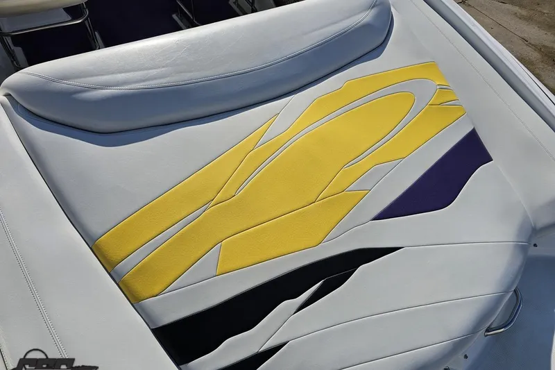 Slide: The Image of 2003 Baja 275 Boss boat seat with vibrant yellow and purple design. - 43