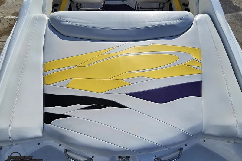 Slide: The Image of 2003 Baja 275 Boss boat seat with vibrant yellow and purple design. - 46