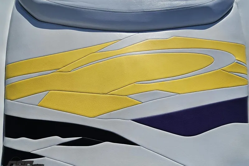 Slide: The Image of 2003 Baja 275 Boss boat seat with vibrant yellow, black, and white design. - 47