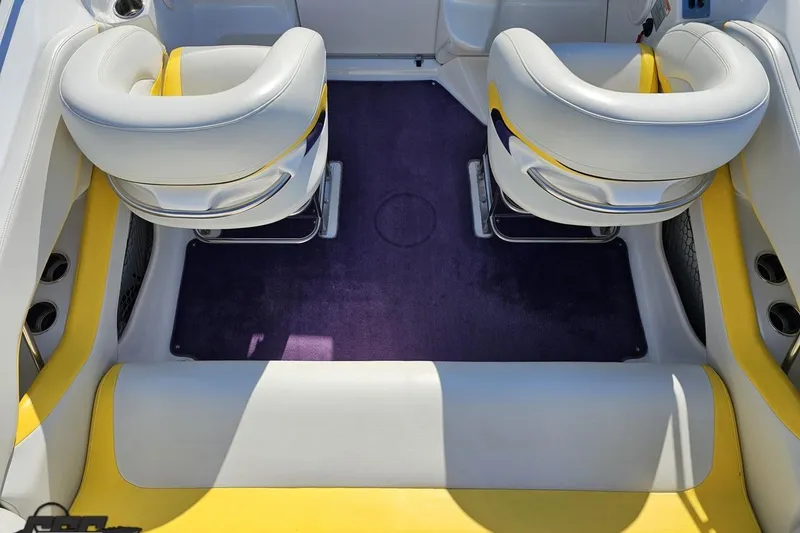 Slide: The Image of Interior of a 2003 Baja 275 Boss boat with white and yellow seating. - 51