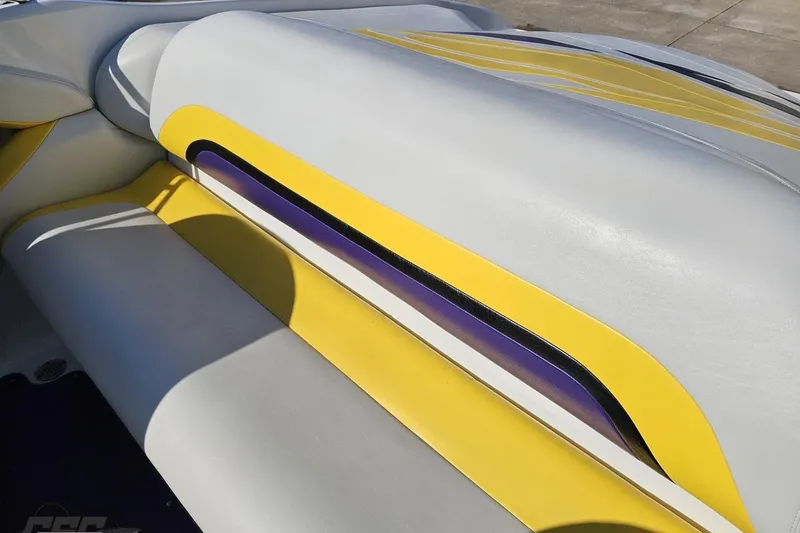 Slide: The Image of 2003 Baja 275 Boss boat interior with yellow and gray upholstery design. - 52
