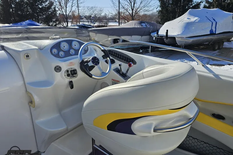 Slide: The Image of 2003 Baja 275 Boss boat cockpit with steering wheel and control panel. - 55