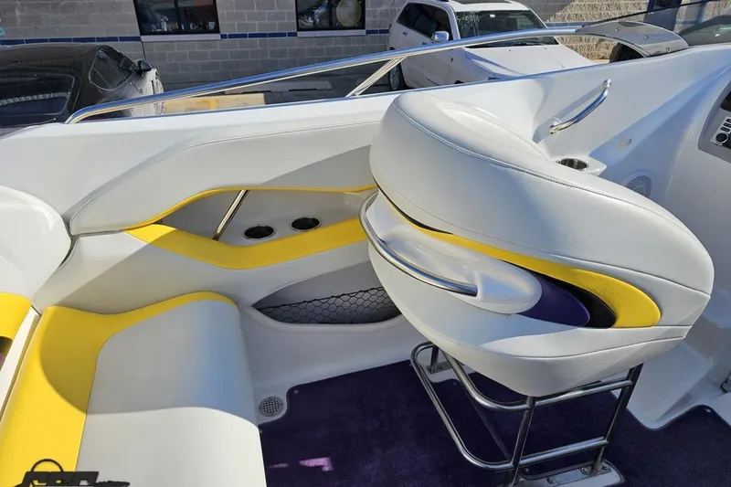 Slide: The Image of 2003 Baja 275 Boss boat interior with white and yellow seating, stainless steel accents. - 57