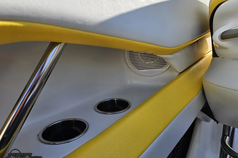 Slide: The Image of Interior of 2003 Baja 275 Boss boat with yellow accents and cup holders. - 58