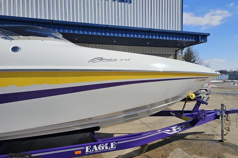 Slide: The Image of 2003 Baja 275 Boss boat on a purple trailer, parked outside a building. - 6