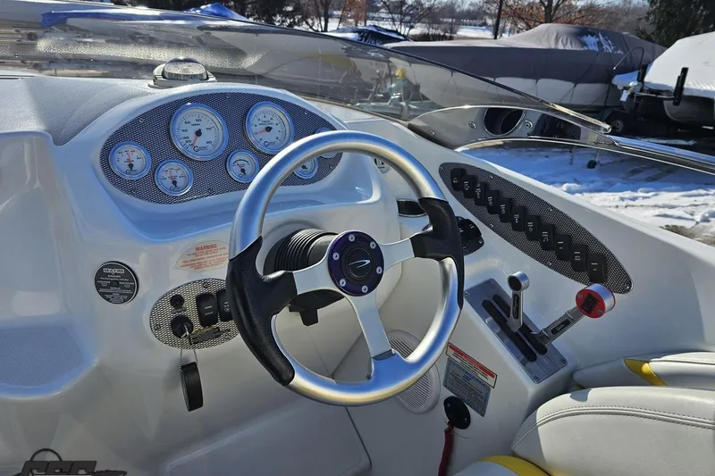 Slide: The Image of 2003 Baja 275 Boss boat dashboard with steering wheel and control panel. - 67