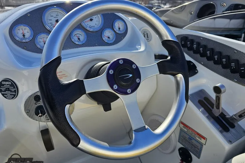 Slide: The Image of Steering wheel and dashboard of 2003 Baja 275 Boss boat with gauges and controls. - 68