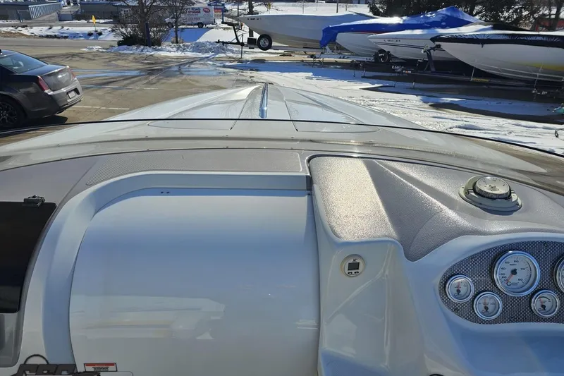 Slide: The Image of 2003 Baja 275 Boss boat dashboard with gauges, parked in snowy marina. - 73