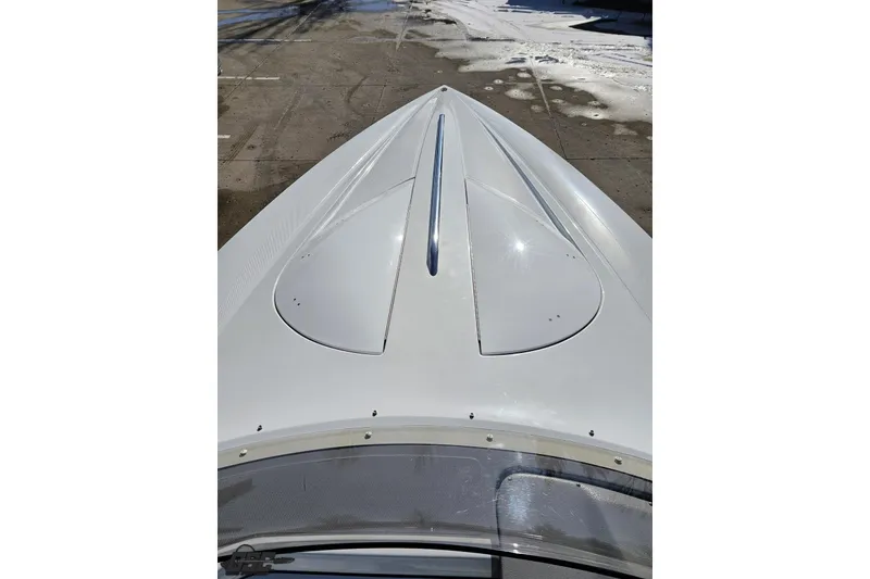 Slide: The Image of 2003 Baja 275 Boss boat bow, sleek white design on a sunny day. - 75