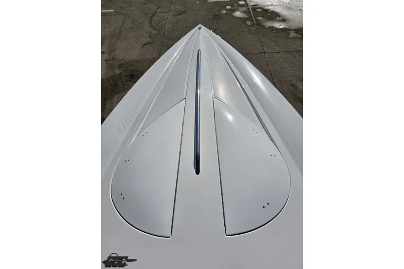 Slide: The Image of 2003 Baja 275 Boss boat hull, sleek white design on concrete surface. - 77