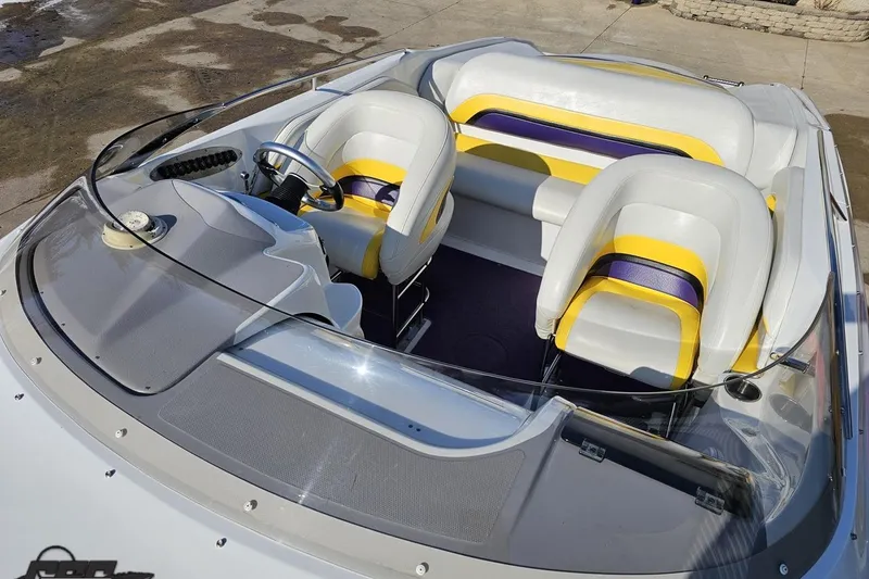 Slide: The Image of 2003 Baja 275 Boss boat interior with white, yellow, and purple seating. - 79