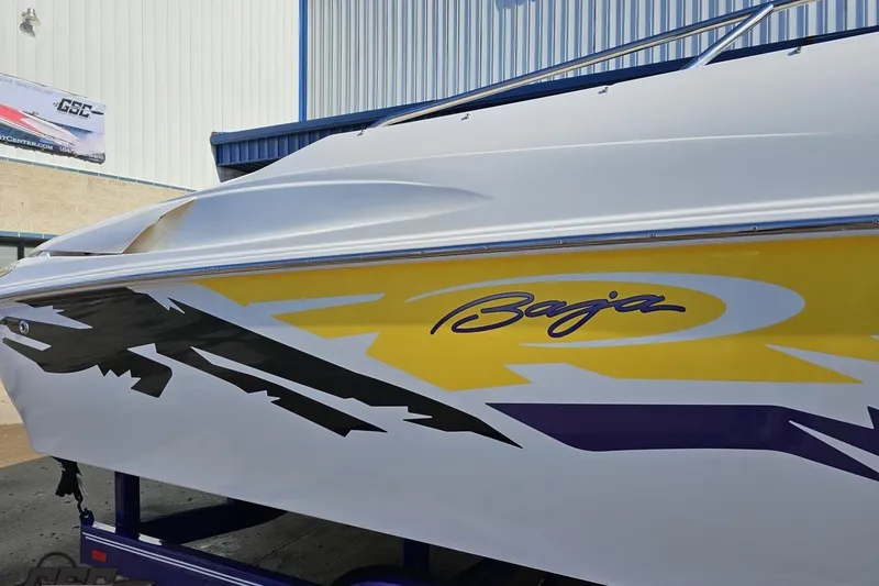 Slide: The Image of 2003 Baja 275 Boss boat with vibrant yellow and black graphics on the side. - 8