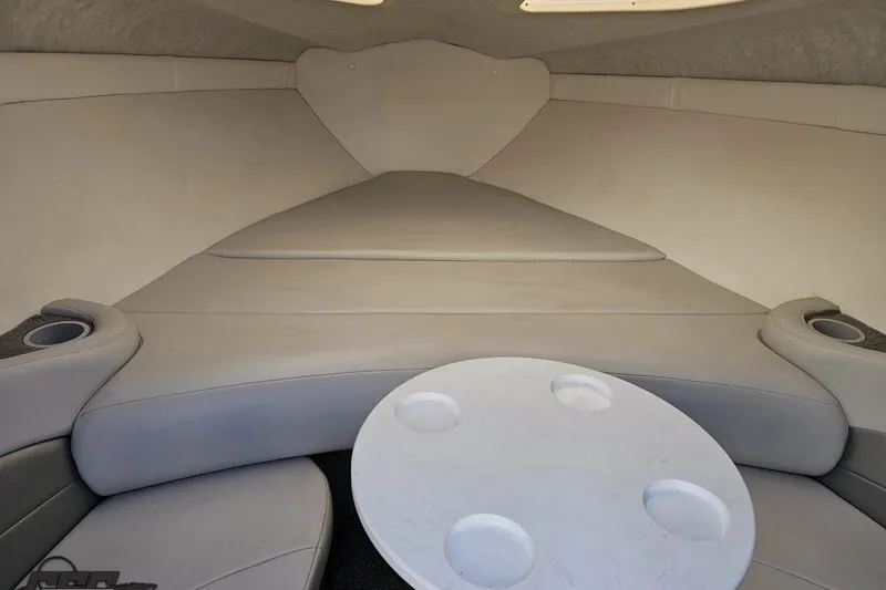Slide: The Image of 2003 Baja 275 Boss boat interior with cushioned seating and round table. - 82