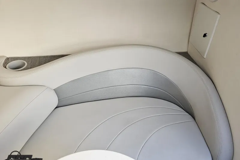Slide: The Image of 2003 Baja 275 Boss boat interior with curved white seating and cup holder. - 84