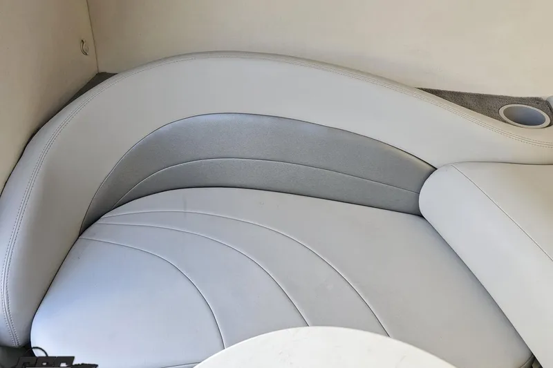 Slide: The Image of 2003 Baja 275 Boss boat interior seating with white and gray upholstery. - 86