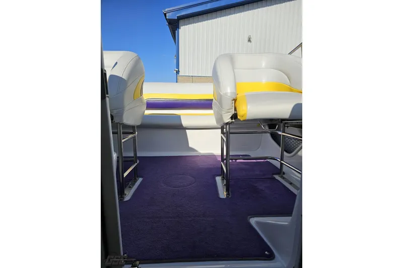 Slide: The Image of Interior of 2003 Baja 275 Boss boat with purple carpet and white-yellow seating. - 89