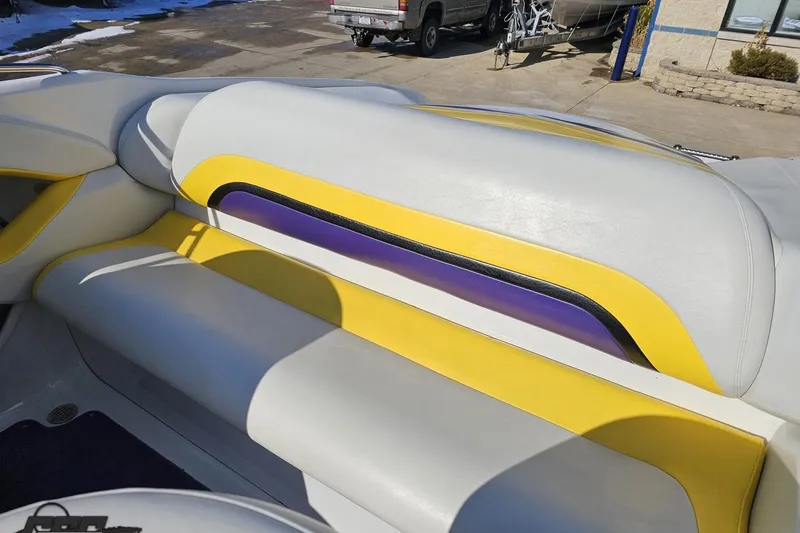 Slide: The Image of 2003 Baja 275 Boss boat interior with yellow, purple, and white seating. - 93