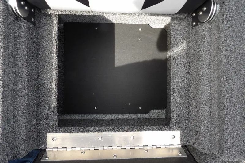 Slide: The Image of 2025 Crestliner 1850 Fish Hawk Tiller storage compartment with carpeted interior and metal hinge. - 18