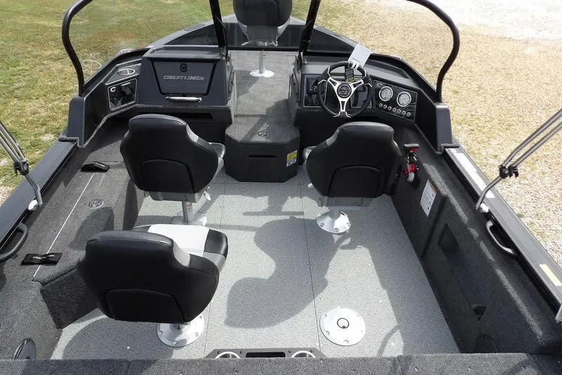 Slide: The Image of 2025 Crestliner 1850 Fish Hawk Tiller interior with seating and steering console. - 19
