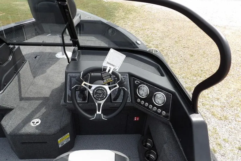 Slide: The Image of 2025 Crestliner 1850 Fish Hawk Tiller boat dashboard with steering wheel and gauges. - 21