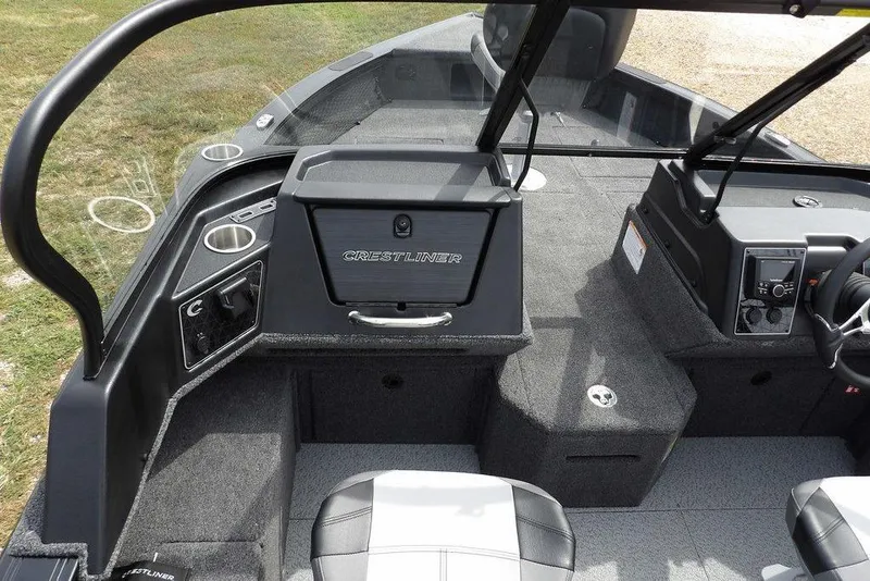 Slide: The Image of 2025 Crestliner 1850 Fish Hawk Tiller interior with modern dashboard and seating. - 25