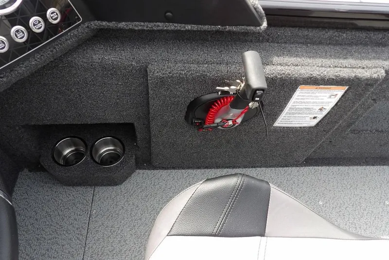 Slide: The Image of 2025 Crestliner 1850 Fish Hawk Tiller interior with control panel and cup holders. - 26