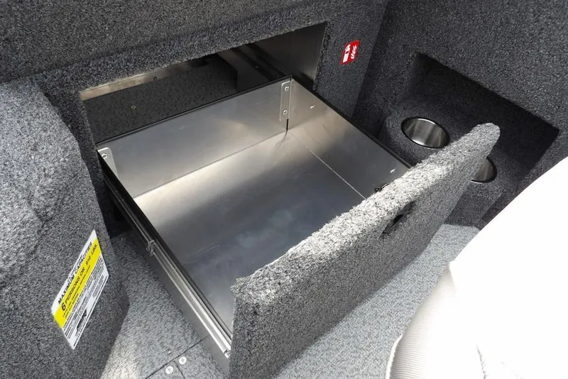 Slide: The Image of 2025 Crestliner 1850 Fish Hawk Tiller storage compartment with carpeted interior and metal drawer. - 27