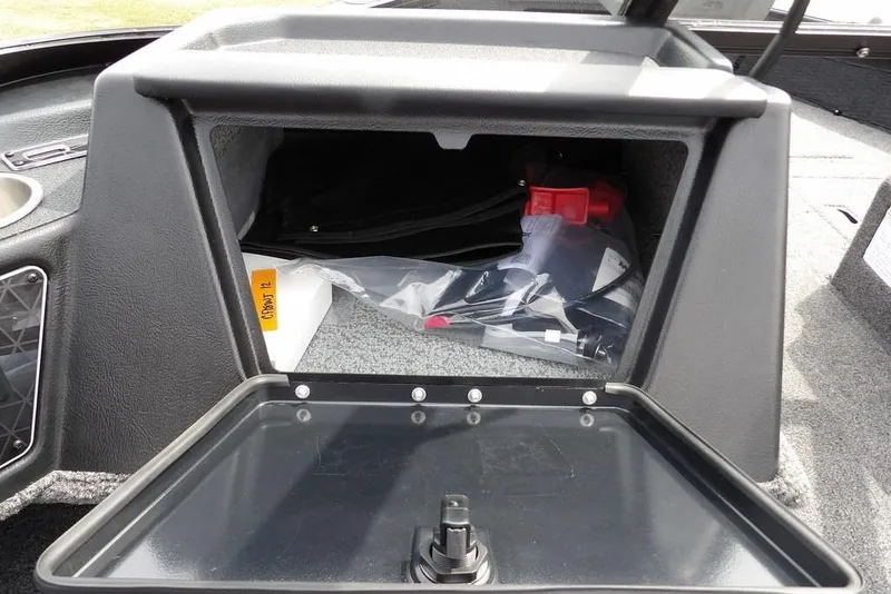 Slide: The Image of 2025 Crestliner 1850 Fish Hawk Tiller storage compartment with open lid and contents visible. - 28