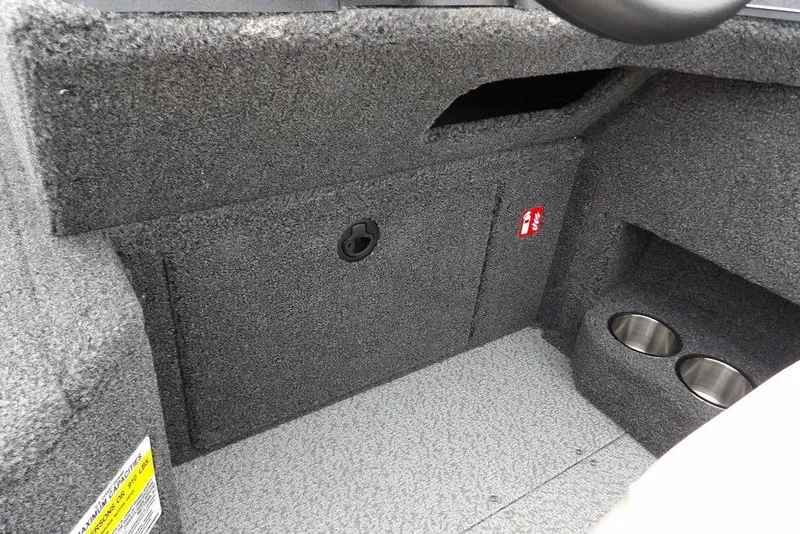 Slide: The Image of 2025 Crestliner 1850 Fish Hawk Tiller interior with storage compartment and cup holders. - 30