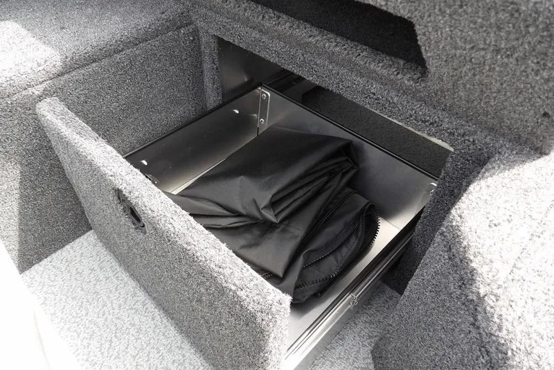 Slide: The Image of Storage compartment in 2025 Crestliner 1850 Fish Hawk Tiller boat, featuring carpeted interior. - 33