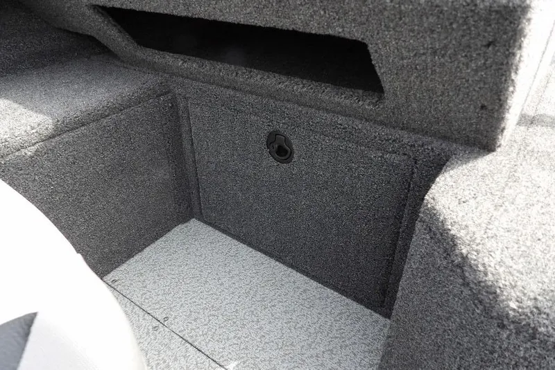 Slide: The Image of 2025 Crestliner 1850 Fish Hawk Tiller interior storage compartment, gray carpeted finish. - 35