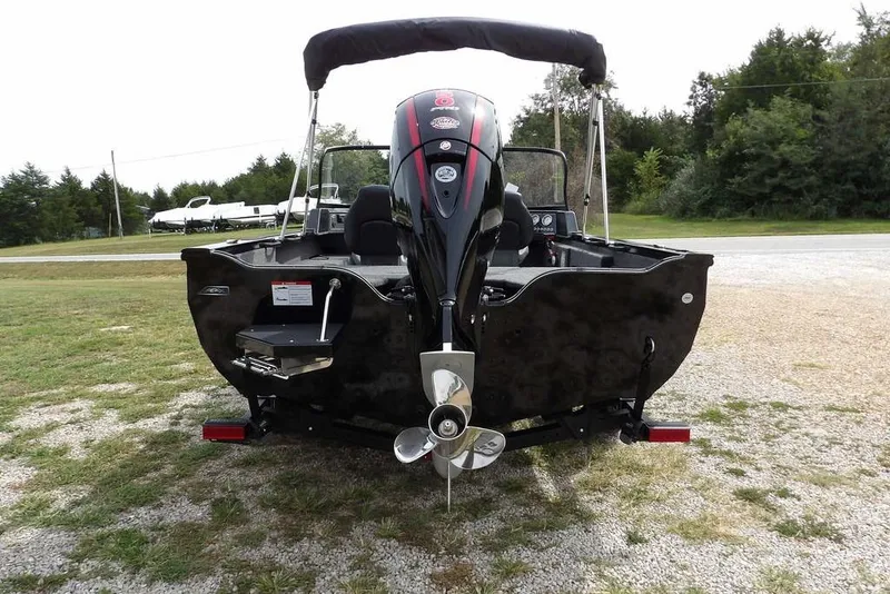 Slide: The Image of 2025 Crestliner 1850 Fish Hawk Tiller boat, rear view, parked on gravel. - 4