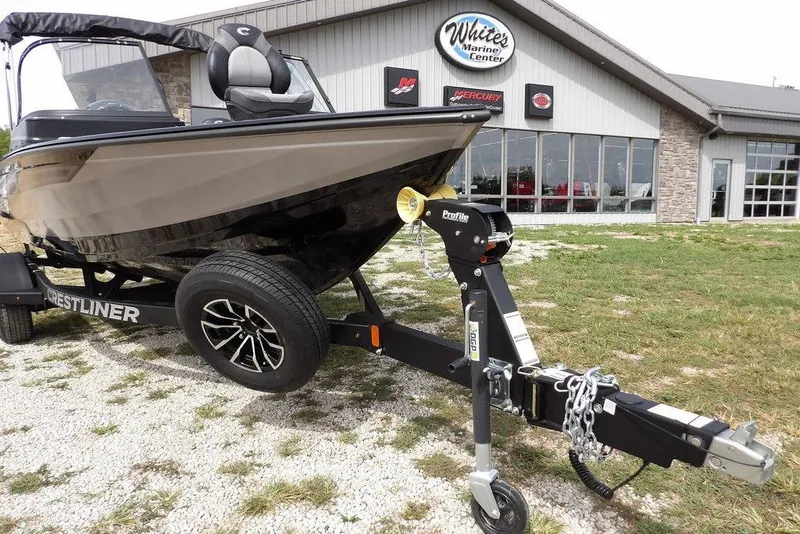 Slide: The Image of 2025 Crestliner 1850 Fish Hawk Tiller boat on trailer outside marine center. - 40