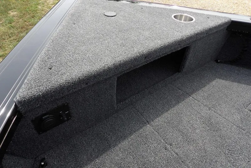 Slide: The Image of 2025 Crestliner 1850 Fish Hawk Tiller boat interior with carpeted storage and cup holder. - 43