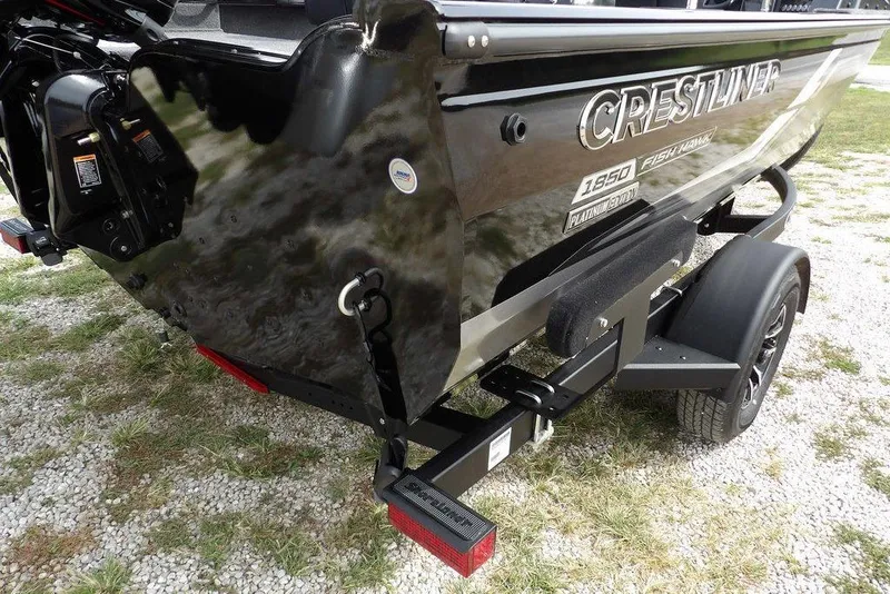 Slide: The Image of 2025 Crestliner 1850 Fish Hawk Tiller boat on trailer, rear view. - 48