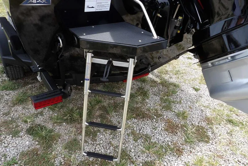 Slide: The Image of 2025 Crestliner 1850 Fish Hawk Tiller with ladder on gravel surface. - 52