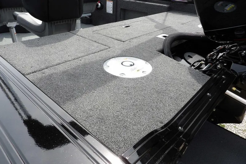 Slide: The Image of 2025 Crestliner 1850 Fish Hawk Tiller boat interior with carpeted deck and seating. - 8