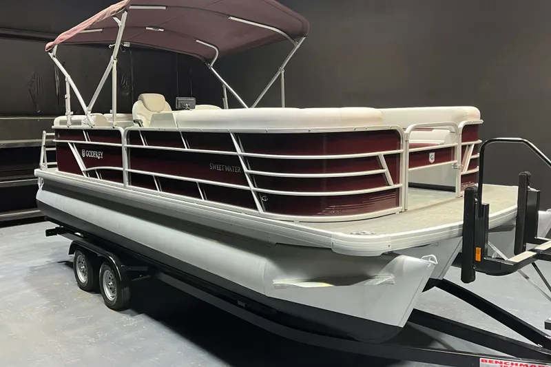 The Image of 2023 Godfrey Sweetwater 2286 C pontoon boat on trailer, maroon and white design. - 1