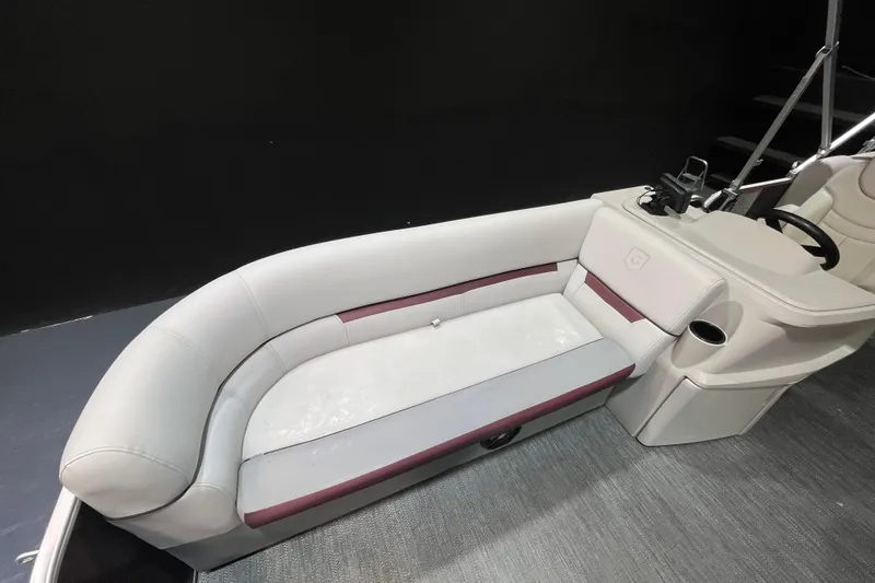 Slide: The Image of 2023 Godfrey Sweetwater 2286 C boat interior with plush seating and steering console. - 10