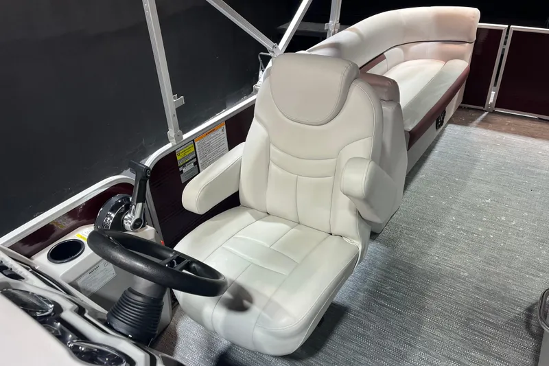 Slide: The Image of Captain's seat of 2023 Godfrey Sweetwater 2286 C pontoon boat, featuring plush white upholstery. - 12