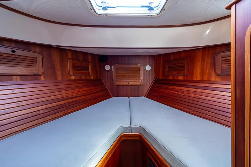 Slide: The Image of Interior cabin of 2002 Hinckley Talaria 40 yacht with wooden paneling and skylight. - 11